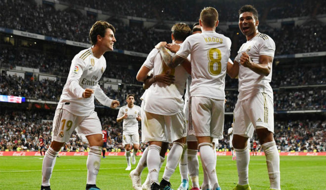 Real Madrid's Spanish defender Alvaro Odriozola (L) and Real Madrid's Brazilian midfielder Casemiro (R) celebrate with teammates their second goal scored by Real Madrid's Brazilian forward Rodrygo during the Spanish league football match between Real Madrid CF and CA Osasuna at the Santiago Bernabeu stadium in Madrid, on September 25, 2019. (Photo by OSCAR DEL POZO / AFP) (Photo credit should read OSCAR DEL POZO/AFP/Getty Images)