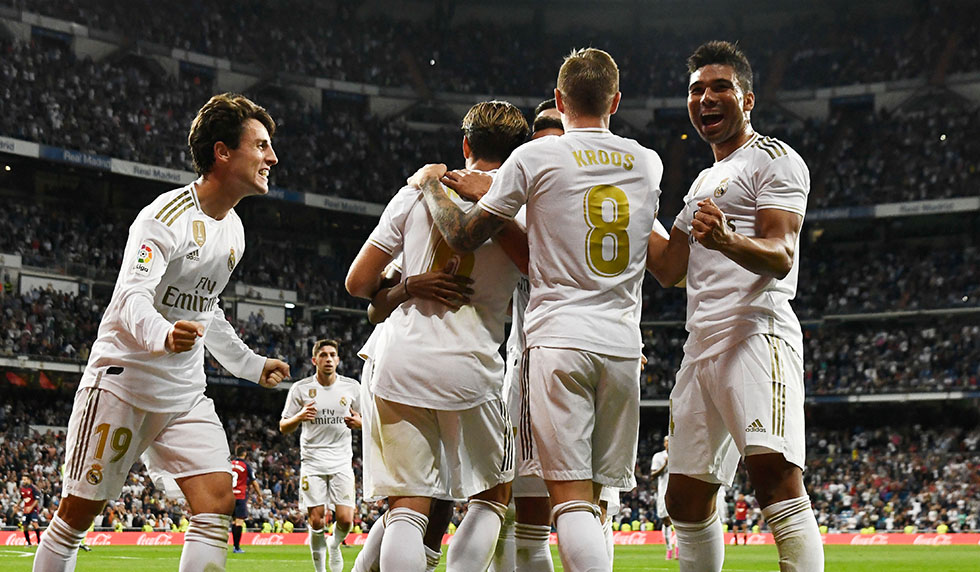 Real Madrid's Spanish defender Alvaro Odriozola (L) and Real Madrid's Brazilian midfielder Casemiro (R) celebrate with teammates their second goal scored by Real Madrid's Brazilian forward Rodrygo during the Spanish league football match between Real Madrid CF and CA Osasuna at the Santiago Bernabeu stadium in Madrid, on September 25, 2019. (Photo by OSCAR DEL POZO / AFP) (Photo credit should read OSCAR DEL POZO/AFP/Getty Images)