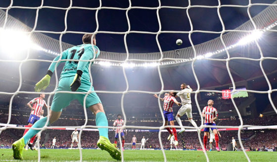 Real Madrid's French forward Karim Benzema (R) jumps for the ball with Atletico Madrid's Montenegrin defender Stefan Savic during the Spanish league football match between Club Atletico de Madrid and Real Madrid CF at the Wanda Metropolitano stadium in Madrid on September 28, 2019. (Photo by JAVIER SORIANO / AFP) (Photo credit should read JAVIER SORIANO/AFP/Getty Images)
