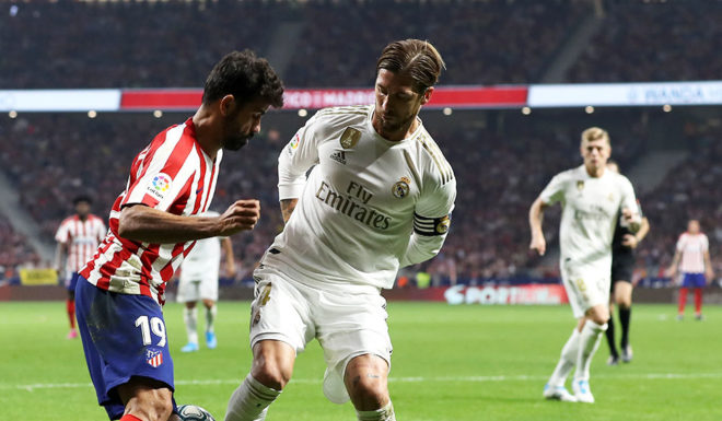 MADRID, SPAIN - SEPTEMBER 28: Diego Costa of Atletico Madrid battles for the ball with Sergio Ramos of Real Madrid during the Liga match between Club Atletico de Madrid and Real Madrid CF at Wanda Metropolitano on September 28, 2019 in Madrid, Spain. (Photo by Angel Martinez/Getty Images)
