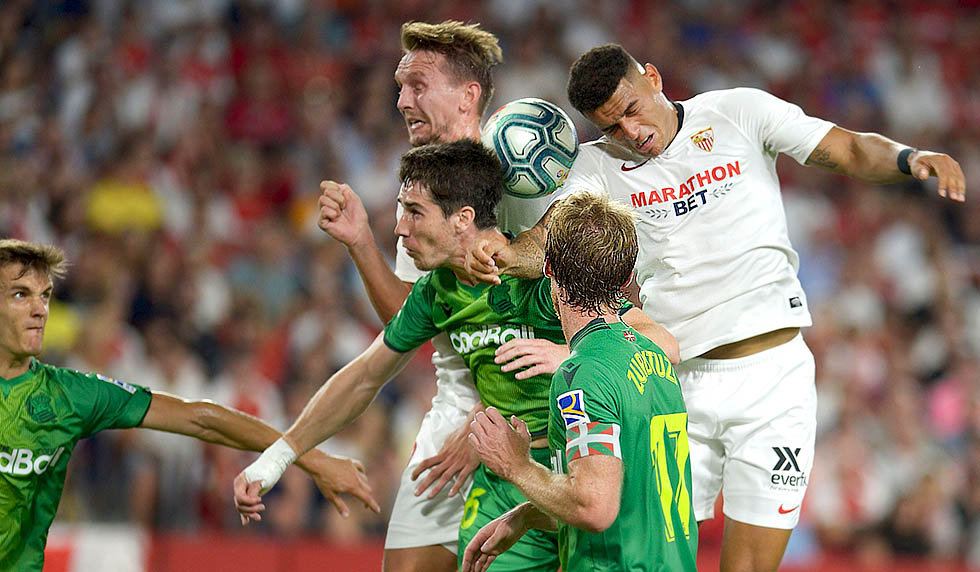 Sevilla's Brazilian defender Diego Carlos (L) jumps for the ball with Real Sociedad's Spanish defender Aritz Elustondo (L) during the Spanish league football match between Sevilla FC and Real Sociedad at the Ramon Sanchez Pizjuan stadium in Seville on September 29, 2019. (Photo by CRISTINA QUICLER / AFP) (Photo credit should read CRISTINA QUICLER/AFP/Getty Images)