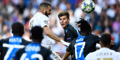 Real Madrid's French forward Karim Benzema (L) and Club Brugge's Ukrainian defender Eduard Sobol jump for the ball during the UEFA Champions league Group A football match between Real Madrid and Club Brugge at the Santiago Bernabeu stadium in Madrid on October 1, 2019. (Photo by OSCAR DEL POZO / AFP) (Photo credit should read OSCAR DEL POZO/AFP/Getty Images)