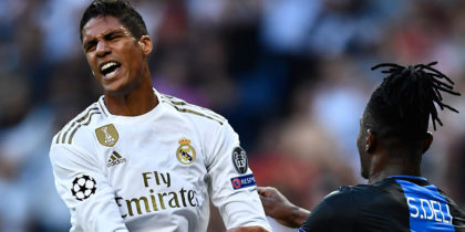 Real Madrid's French defender Raphael Varane (L) reacts next to Club Brugge's Ivorian defender Simon Deli during the UEFA Champions league Group A football match between Real Madrid and Club Brugge at the Santiago Bernabeu stadium in Madrid on October 1, 2019. (Photo by OSCAR DEL POZO / AFP) (Photo credit should read OSCAR DEL POZO/AFP/Getty Images)
