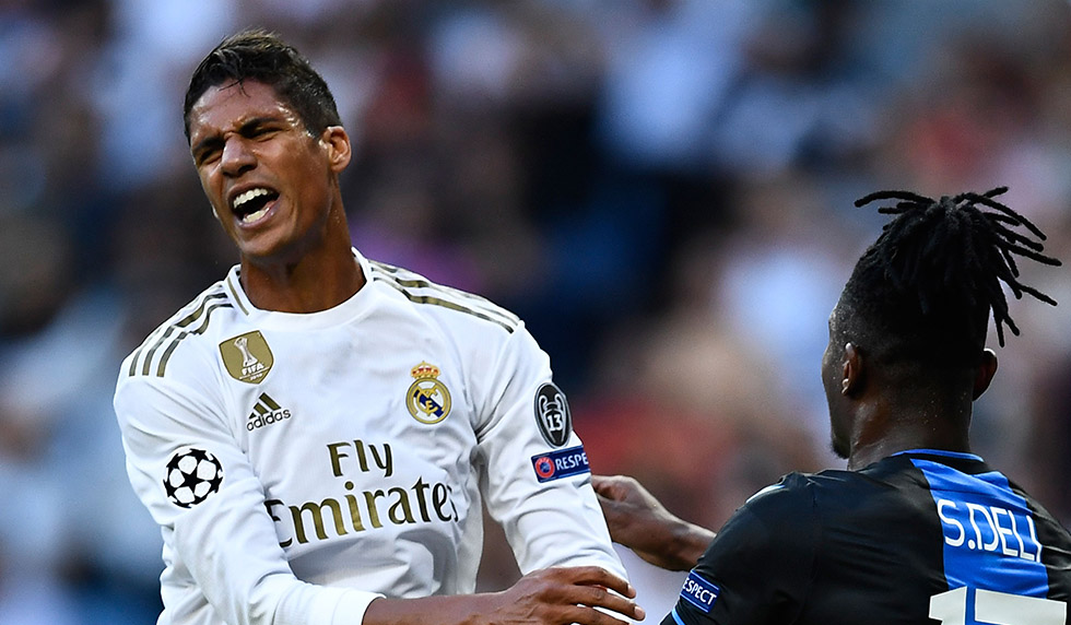 Real Madrid's French defender Raphael Varane (L) reacts next to Club Brugge's Ivorian defender Simon Deli during the UEFA Champions league Group A football match between Real Madrid and Club Brugge at the Santiago Bernabeu stadium in Madrid on October 1, 2019. (Photo by OSCAR DEL POZO / AFP) (Photo credit should read OSCAR DEL POZO/AFP/Getty Images)