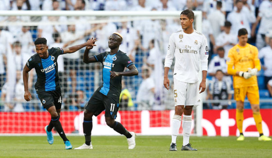 Club's Emmanuel Bonaventure Dennis celebrates after scoring the 0-1 goal with Club's Krepin Diatta while Real's Raphael Varane shows deception at a game between Belgian soccer team Club Brugge and Spanish club Real Madrid on the second day (out of 6) in the group stage of the UEFA Champions League , Tuesday 01 October 2019 in Madrid, Spain. BELGA PHOTO BRUNO FAHY (Photo credit should read BRUNO FAHY/AFP/Getty Images)