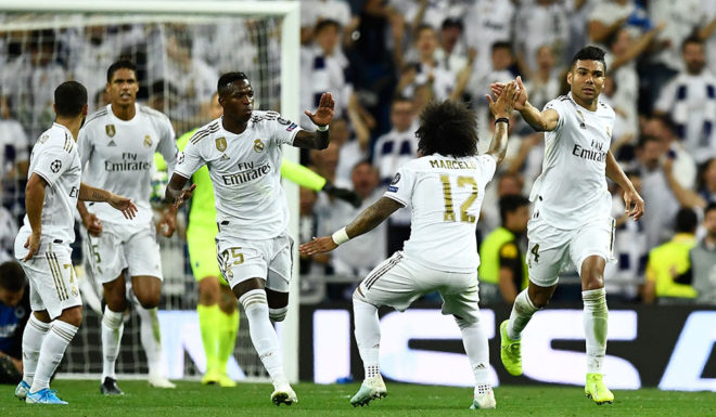 Real Madrid's Brazilian midfielder Casemiro (R) celebrates after scoring during the UEFA Champions league Group A football match between Real Madrid and Club Brugge at the Santiago Bernabeu stadium in Madrid on October 1, 2019. (Photo by OSCAR DEL POZO / AFP) (Photo credit should read OSCAR DEL POZO/AFP/Getty Images)