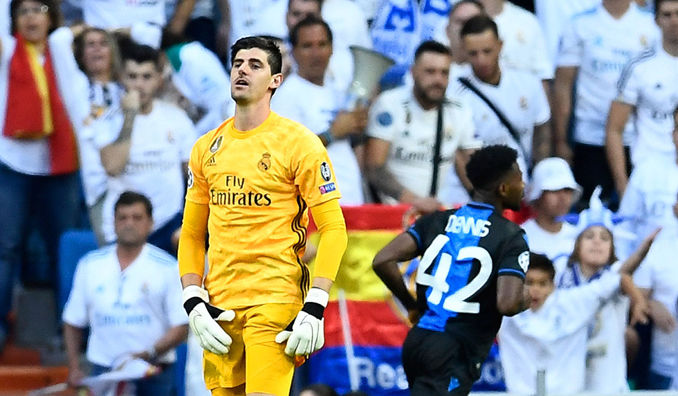 Real Madrid's Belgian goalkeeper Thibaut Courtois (L) reacts after Club Brugge's Nigerian forward Emmanuel Bonaventure scored a second goal during the UEFA Champions league Group A football match between Real Madrid and Club Brugge at the Santiago Bernabeu stadium in Madrid on October 1, 2019. (Photo by OSCAR DEL POZO / AFP) (Photo credit should read OSCAR DEL POZO/AFP/Getty Images)