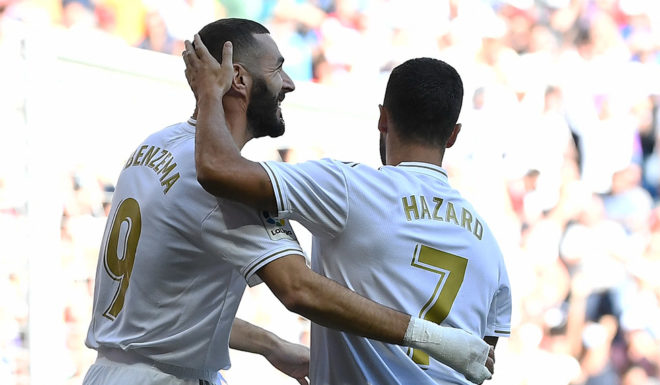 Real Madrid's French forward Karim Benzema (L) celebrates scoring the opening goal with Real Madrid's Belgian forward Eden Hazard during the Spanish league football match between Real Madrid CF and Granada FC at the Santiago Bernabeu stadium in Madrid on October 5, 2019. (Photo by PIERRE-PHILIPPE MARCOU / AFP) (Photo by PIERRE-PHILIPPE MARCOU/AFP via Getty Images)