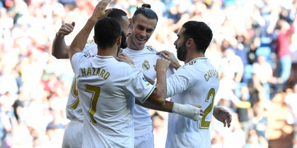 Real Madrid's French forward Karim Benzema (L) celebrates with teammates scoring the opening goal during the Spanish league football match between Real Madrid CF and Granada FC at the Santiago Bernabeu stadium in Madrid on October 5, 2019. (Photo by PIERRE-PHILIPPE MARCOU / AFP) (Photo by PIERRE-PHILIPPE MARCOU/AFP via Getty Images)