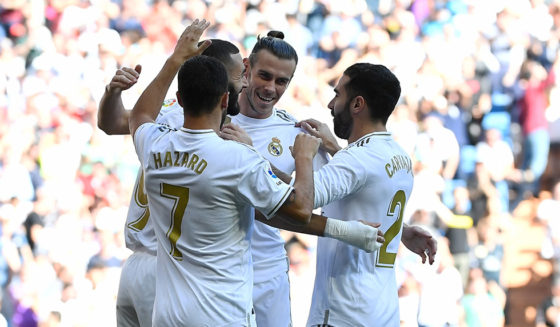Real Madrid's French forward Karim Benzema (L) celebrates with teammates scoring the opening goal during the Spanish league football match between Real Madrid CF and Granada FC at the Santiago Bernabeu stadium in Madrid on October 5, 2019. (Photo by PIERRE-PHILIPPE MARCOU / AFP) (Photo by PIERRE-PHILIPPE MARCOU/AFP via Getty Images)