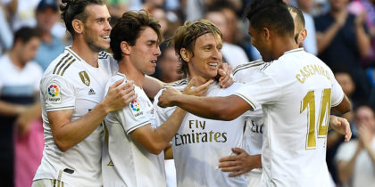 Real Madrid's Croatian midfielder Luka Modric (C) celebrates with teammates scoring his team's third goal during the Spanish league football match between Real Madrid CF and Granada FC at the Santiago Bernabeu stadium in Madrid on October 5, 2019. (Photo by PIERRE-PHILIPPE MARCOU / AFP) (Photo by PIERRE-PHILIPPE MARCOU/AFP via Getty Images)