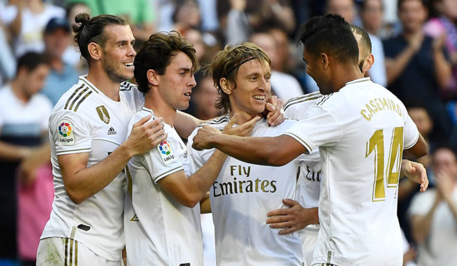 Real Madrid's Croatian midfielder Luka Modric (C) celebrates with teammates scoring his team's third goal during the Spanish league football match between Real Madrid CF and Granada FC at the Santiago Bernabeu stadium in Madrid on October 5, 2019. (Photo by PIERRE-PHILIPPE MARCOU / AFP) (Photo by PIERRE-PHILIPPE MARCOU/AFP via Getty Images)