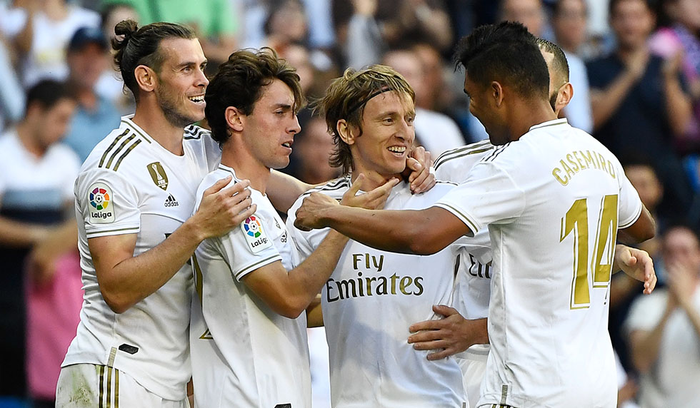 Real Madrid's Croatian midfielder Luka Modric (C) celebrates with teammates scoring his team's third goal during the Spanish league football match between Real Madrid CF and Granada FC at the Santiago Bernabeu stadium in Madrid on October 5, 2019. (Photo by PIERRE-PHILIPPE MARCOU / AFP) (Photo by PIERRE-PHILIPPE MARCOU/AFP via Getty Images)