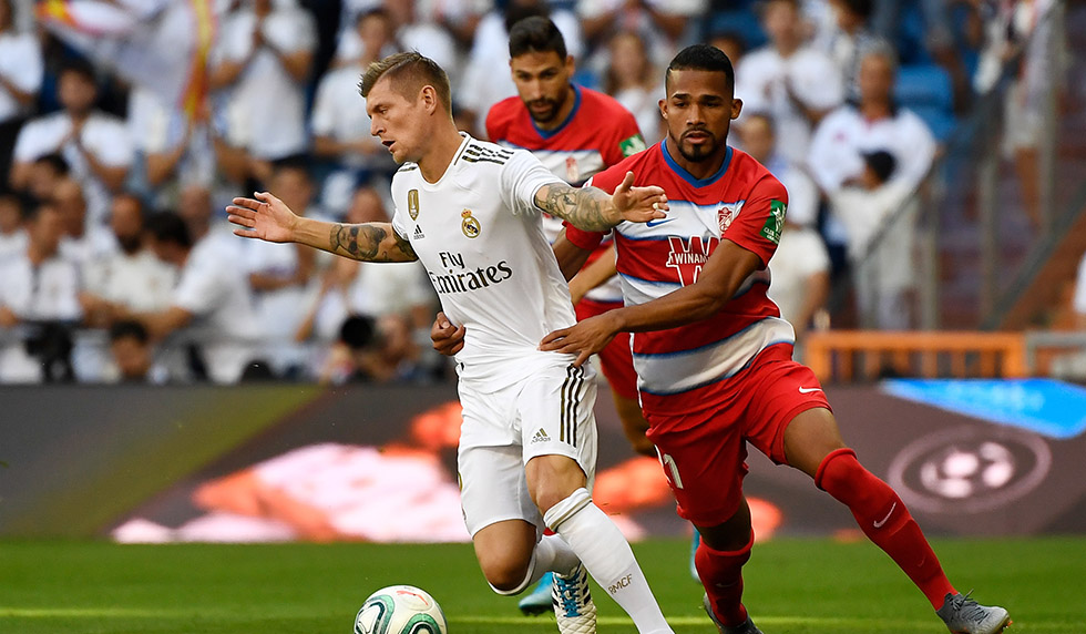 Real Madrid's German midfielder Toni Kroos (L) vies with Granada's Venezuelan midfielder Yangel Herrera during the Spanish league football match between Real Madrid CF and Granada FC at the Santiago Bernabeu stadium in Madrid on October 5, 2019. (Photo by PIERRE-PHILIPPE MARCOU / AFP) (Photo by PIERRE-PHILIPPE MARCOU/AFP via Getty Images)