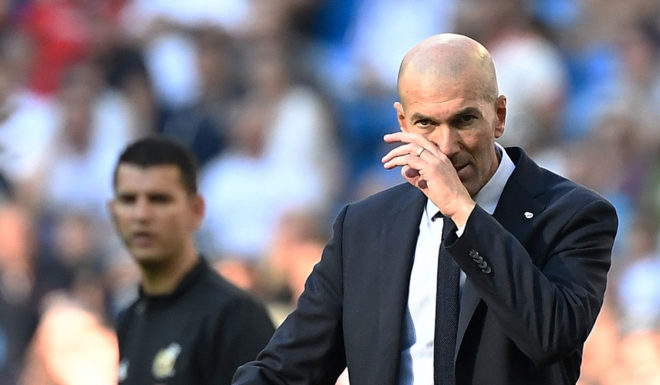 Real Madrid's French coach Zinedine Zidane (R) gestures during the Spanish league football match between Real Madrid CF and Granada FC at the Santiago Bernabeu stadium in Madrid on October 5, 2019. (Photo by PIERRE-PHILIPPE MARCOU / AFP) (Photo by PIERRE-PHILIPPE MARCOU/AFP via Getty Images)