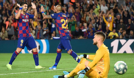 Barcelona's Uruguayan forward Luis Suarez (L) congratulates Barcelona's Chilean midfielder Arturo Vidal for his goal during the Spanish league football match between FC Barcelona and Sevilla FC at the Camp Nou stadium in Barcelona on October 6, 2019. (Photo by Josep LAGO / AFP) (Photo by JOSEP LAGO/AFP via Getty Images)