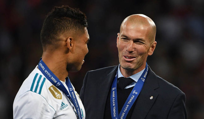 Real Madrid's Brazilian midfielder Casemiro speaks with Real Madrid's French coach Zinedine Zidane (R) as Real Madrid players celebrate winning the UEFA Champions League final football match between Liverpool and Real Madrid at the Olympic Stadium in Kiev, Ukraine on May 26, 2018. - Real Madrid defeated Liverpool 3-1. (Photo by Paul ELLIS / AFP) (Photo credit should read PAUL ELLIS/AFP/Getty Images)