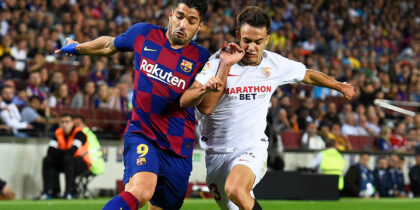 Barcelona's Uruguayan forward Luis Suarez (L) vies with Sevilla's Spanish defender Sergio Reguilon during the Spanish league football match between FC Barcelona and Sevilla FC at the Camp Nou stadium in Barcelona on October 6, 2019. (Photo by Josep LAGO / AFP) (Photo by JOSEP LAGO/AFP via Getty Images)