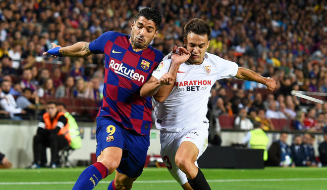 Luis Suarez, Sergio Reguilón Barcelona's Uruguayan forward Luis Suarez (L) vies with Sevilla's Spanish defender Sergio Reguilon during the Spanish league football match between FC Barcelona and Sevilla FC at the Camp Nou stadium in Barcelona on October 6, 2019. (Photo by Josep LAGO / AFP) (Photo by JOSEP LAGO/AFP via Getty Images)