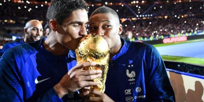 France's defender Raphael Varane (L) and France's midfielder Kylian Mbappe (R) kiss the 2018 World Cup trophy as they celebrate during a ceremony for the victory of the 2018 World Cup at the end of the UEFA Nations League football match between France and Netherlands at the Stade de France stadium, in Saint-Denis, northern of Paris, on September 9, 2018. (Photo by FRANCK FIFE / AFP) (Photo credit should read FRANCK FIFE/AFP/Getty Images)