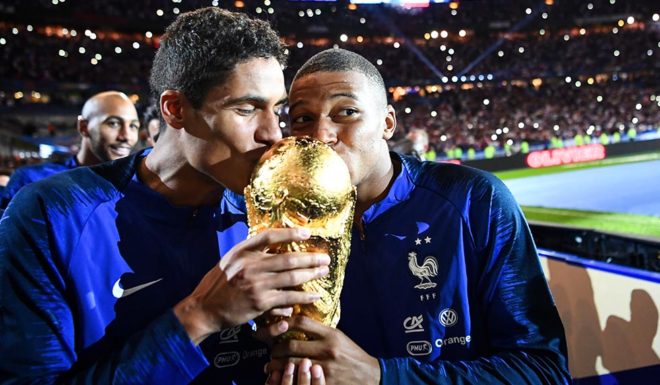 Varane, Mbappé France's defender Raphael Varane (L) and France's midfielder Kylian Mbappe (R) kiss the 2018 World Cup trophy as they celebrate during a ceremony for the victory of the 2018 World Cup at the end of the UEFA Nations League football match between France and Netherlands at the Stade de France stadium, in Saint-Denis, northern of Paris, on September 9, 2018. (Photo by FRANCK FIFE / AFP) (Photo credit should read FRANCK FIFE/AFP/Getty Images)