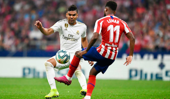 Real Madrid's Brazilian midfielder Casemiro (L) challenges Atletico Madrid's French midfielder Thomas Lemar during the Spanish league football match between Club Atletico de Madrid and Real Madrid CF at the Wanda Metropolitano stadium in Madrid on September 28, 2019. (Photo by OSCAR DEL POZO / AFP) (Photo credit should read OSCAR DEL POZO/AFP/Getty Images)