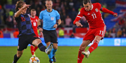 Wales' striker Gareth Bale (R) has an unsuccessful shot under pressure from Croatia's midfielder Luka Modric (L) during the Euro 2020 football qualification match between Wales and Croatia at Cardiff City Stadium, Cardiff on October 13, 2019. (Photo by GEOFF CADDICK / AFP) (Photo by GEOFF CADDICK/AFP via Getty Images)