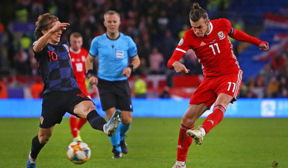 Wales' striker Gareth Bale (R) has an unsuccessful shot under pressure from Croatia's midfielder Luka Modric (L) during the Euro 2020 football qualification match between Wales and Croatia at Cardiff City Stadium, Cardiff on October 13, 2019. (Photo by GEOFF CADDICK / AFP) (Photo by GEOFF CADDICK/AFP via Getty Images)