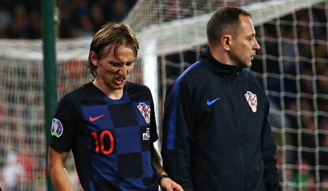 Croatia's midfielder Luka Modric (C) is helped from the pitch after picking up an injury during the Euro 2020 football qualification match between Wales and Croatia at Cardiff City Stadium, Cardiff on October 13, 2019. (Photo by GEOFF CADDICK / AFP) (Photo by GEOFF CADDICK/AFP via Getty Images)
