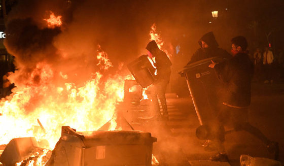 TOPSHOT - Protesters burn garbage containers during protests in Barcelona on October 15, 2019, as Catalonia geared up for more upheaval a day after thousands of pro-independence activists stormed Barcelona airport in an angry response to Spain's jailing of nine of its leaders following a failed secession bid. (Photo by LLUIS GENE / AFP) (Photo by LLUIS GENE/AFP via Getty Images)