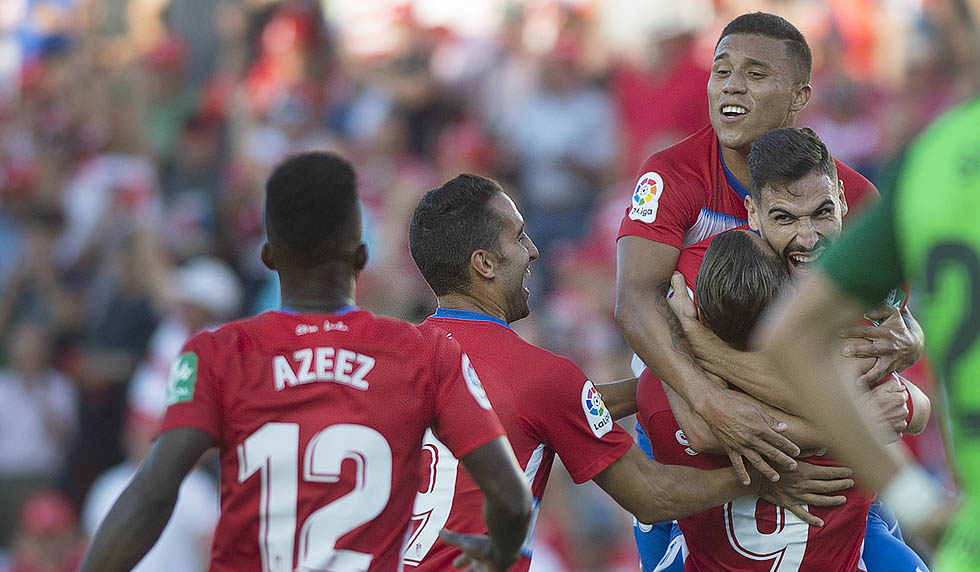 Granada's Spanish midfielder Antonio Puertas (Top) celebrates with Spanish forward Roberto Soldado after scoring during the Spanish league football match between Granada FC and Club Deportivo Leganes SAD at Nuevo Los Carmenes stadium in Granada on September 28, 2019. (Photo by JORGE GUERRERO / AFP) (Photo credit should read JORGE GUERRERO/AFP/Getty Images)