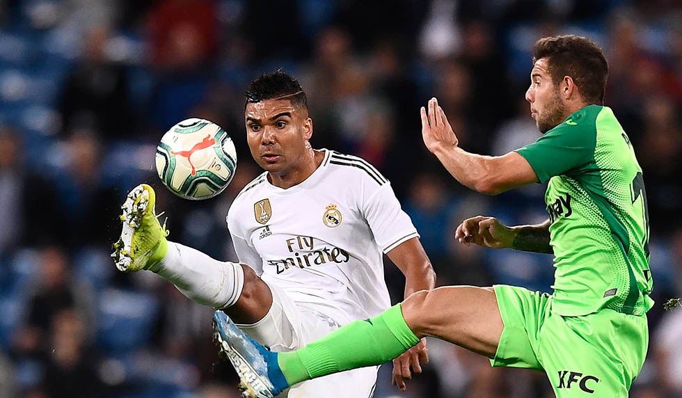 Real Madrid's Brazilian midfielder Casemiro (L) vies with Leganes' Spanish forward Aitor Ruibal during the Spanish league football match between Real Madrid CF and Club Deportivo Leganes SAD at the Santiago Bernabeu stadium in Madrid on October 30, 2019. (Photo by OSCAR DEL POZO / AFP) (Photo by OSCAR DEL POZO/AFP via Getty Images)