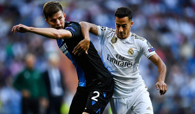 Club Brugge's Ukrainian defender Eduard Sobol (L) challenges Real Madrid's Spanish forward Lucas Vazquez during the UEFA Champions league Group A football match between Real Madrid and Club Brugge at the Santiago Bernabeu stadium in Madrid on October 1, 2019. (Photo by OSCAR DEL POZO / AFP) (Photo credit should read OSCAR DEL POZO/AFP/Getty Images)