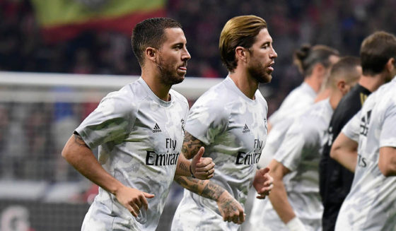 Real Madrid's Belgian forward Eden Hazard (L) and Real Madrid's Spanish defender Sergio Ramos (C) warm up before the Spanish league football match between Club Atletico de Madrid and Real Madrid CF at the Wanda Metropolitano stadium in Madrid on September 28, 2019. (Photo by JAVIER SORIANO / AFP) (Photo credit should read JAVIER SORIANO/AFP via Getty Images)
