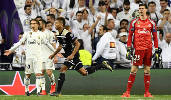 Ajax's Brazilian forward David Neres (C) celebrates past Real Madrid's Belgian goalkeeper Thibaut Courtois (R) and Real Madrid's Croatian midfielder Luka Modric (L) after scoring a goal during the UEFA Champions League round of 16 second leg football match between Real Madrid CF and Ajax at the Santiago Bernabeu stadium in Madrid on March 5, 2019. (Photo by GABRIEL BOUYS / AFP) (Photo credit should read GABRIEL BOUYS/AFP/Getty Images)