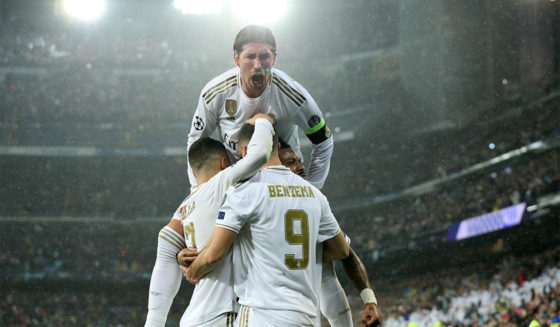 MADRID, SPAIN - NOVEMBER 26: Sergio Ramos celebrates with Karim Benzema of Real Madrid after scoring his team's first goal during the UEFA Champions League group A match between Real Madrid and Paris Saint-Germain at Bernabeu on November 26, 2019 in Madrid, Spain. (Photo by Angel Martinez/Getty Images)