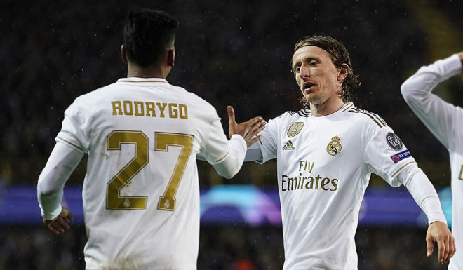 Real Madrid's Brazilian forward Rodrygo (L) celebrates with Real Madrid's Croatian midfielder Luka Modric (C) and Real Madrid's Spanish defender Alvaro Odriozola after scoring the opener during the UEFA Champions League Group A football match between Club Brugge and Real Madrid CF at the Jan Breydel Stadium in Bruges on December 11, 2019. (Photo by KENZO TRIBOUILLARD / AFP) (Photo by KENZO TRIBOUILLARD/AFP via Getty Images)