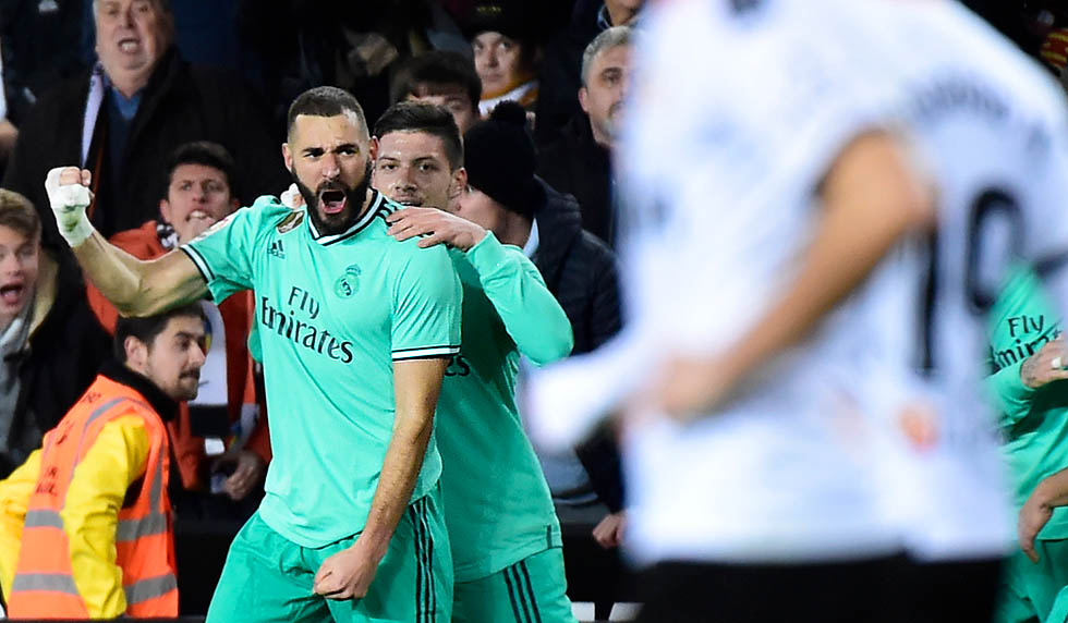 Real Madrid's French forward Karim Benzema celebrates after scoring a goal during the Spanish League football match between Valencia CF and Real Madrid, at the Mestalla stadium in Valencia, on December 15, 2019. (Photo by JOSE JORDAN / AFP) (Photo by JOSE JORDAN/AFP via Getty Images)