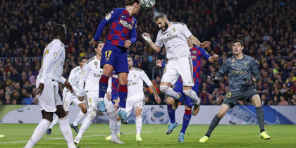 BARCELONA, SPAIN - DECEMBER 18: Karim Benzema of Real Madrid clears under pressure from Antoine Griezmann of Barcelona during the Liga match between FC Barcelona and Real Madrid CF at Camp Nou on December 18, 2019 in Barcelona, Spain. (Photo by Eric Alonso/Getty Images)