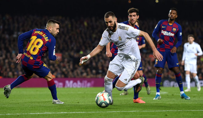 BARCELONA, SPAIN - DECEMBER 18: Karim Benzema of Real Madrid takes on Jordi Alba of Barcelona during the Liga match between FC Barcelona and Real Madrid CF at Camp Nou on December 18, 2019 in Barcelona, Spain. (Photo by Alex Caparros/Getty Images)