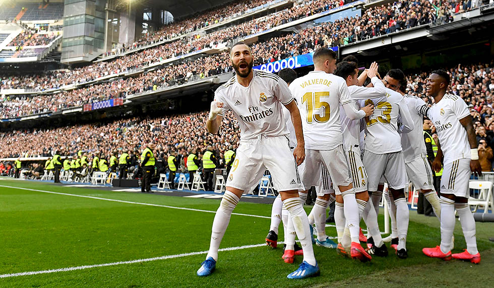 Real Madrid's French forward Karim Benzema (L) celebrates after scoring a goal during the Spanish league football match between Real Madrid CF and Club Atletico de Madrid at the Santiago Bernabeu stadium in Madrid on February 1, 2020. (Photo by PIERRE-PHILIPPE MARCOU / AFP) (Photo by PIERRE-PHILIPPE MARCOU/AFP via Getty Images)