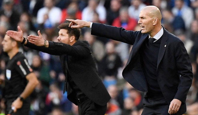 TOPSHOT - Atletico Madrid's Argentinian coach Diego Simeone and Real Madrid's French coach Zinedine Zidane (R) gesture during the Spanish league football match between Real Madrid CF and Club Atletico de Madrid at the Santiago Bernabeu stadium in Madrid on February 1, 2020. (Photo by PIERRE-PHILIPPE MARCOU / AFP) (Photo by PIERRE-PHILIPPE MARCOU/AFP via Getty Images)