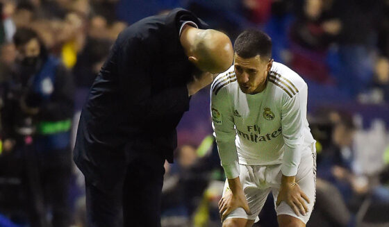 Real Madrid's French coach Zinedine Zidane (L) talks to Real Madrid's Belgian forward Eden Hazard during the Spanish league football match Levante UD against Real Madrid CF at the Ciutat de Valencia stadium in Valencia on February 22, 2020. (Photo by JOSE JORDAN / AFP) (Photo by JOSE JORDAN/AFP via Getty Images)